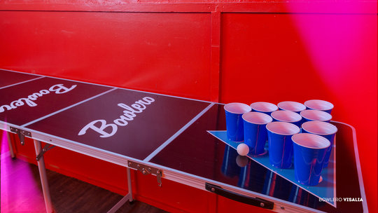 beer pong table with red wall