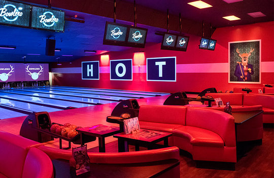 Lanes with plush red couches and black lighting